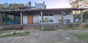 a house with a bench in front of it at Chalé Bela Vista in Torres