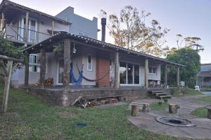 a house with a porch with a yard at Chalé Bela Vista in Torres