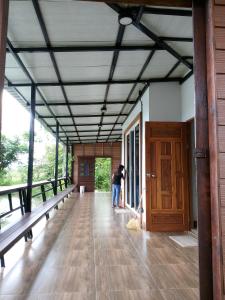 a person taking a picture in the hallway of a house at Huan Janto Homestay - Metta in Chiang Mai