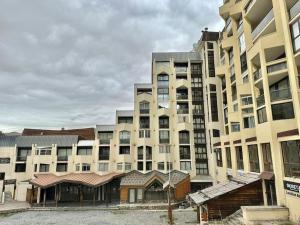 a large apartment building with a building at Studio front de neige pelevos in Isola