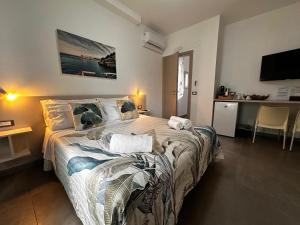 a bedroom with a large bed and a kitchen at Biscotti s room in Peschici