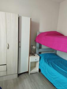 a bedroom with a bunk bed and a night stand at Departamento Temporario San Pedro in San Pedro +2 photos