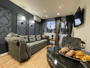 a living room with a couch and a table at CTS Apartament CZARNA PERŁA in Ustroń +6 photos