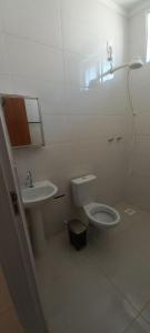 a white bathroom with a toilet and a sink at hostel casa 2 in Araraquara +19 photos