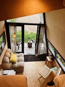 an overhead view of a living room with a large window at Slapen op de Dijk - Tiny House in Kraggenburg