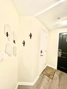 a room with white walls and a black door at Alpenglow Lodge Bear Wonder One Bedroom by MVA in Whistler
