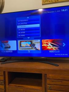 a flat screen tv sitting on top of a wooden table at Villa Maiteren Etxea- 4 Beds property with private pool in Playa Blanca