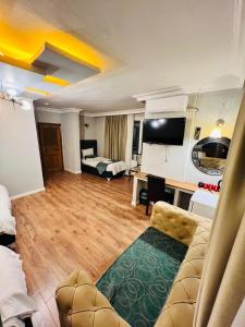 a living room with a couch and a desk in a room at Pembe Köşk Old City Center in Istanbul +198 photos