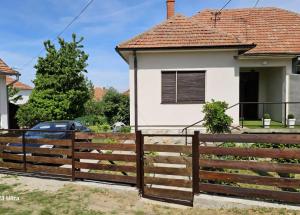 a wooden fence in front of a house at NAS DOM OPLENAC in Topola