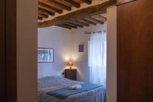 a bedroom with a bed with a stuffed animal on it at Alla Meria in Castiglione della Pescaia