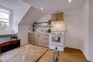 a kitchen with a white stove top oven next to a window at Chambre 302 de l'hôtel Victoria confortable et moderne in Saint-Pascal
