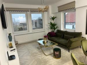 a living room with a couch and a table at Elite Apartment in Sibiu
