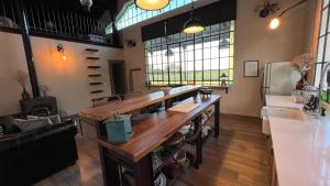 a large room with a large wooden table and a couch at Rancho Capilla in Capilla del Señor