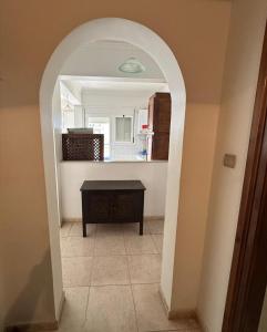 an archway in a kitchen with a table and a mirror at Belle vue à Bel air in Oran