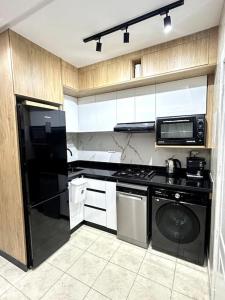 a kitchen with a black refrigerator and a dishwasher at Modern appartement in Agadir in Agadir +41 photos