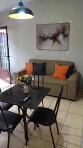 a living room with a table and a couch at Hotel Glórias - Glórias 3 in Quirinópolis