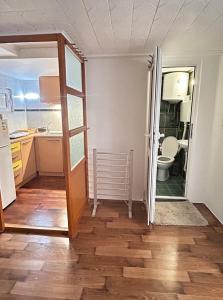an open door to a kitchen with a toilet at Emily's house in Čelarevo