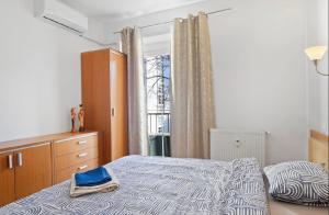 a bedroom with a bed and a window at Aura centrum in Piešťany