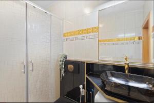 a bathroom with a sink and a mirror at Aura centrum in Piešťany +16 photos