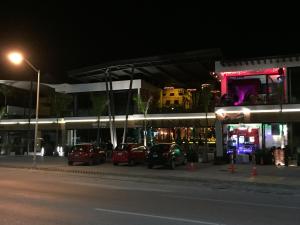 a group of cars parked in a parking lot at night at Mango 78 in Playa del Carmen