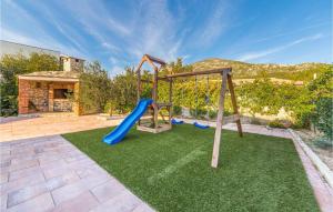 a backyard with a playground with a slide at Holiday Home Kremena 72 With Outdoor Swimmingpool in Klek +35 photos