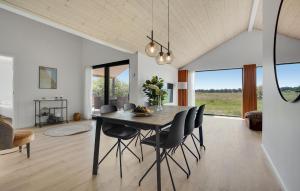 a dining room with a table and chairs at 3 Bedroom Stunning Home In Jerup in Jerup