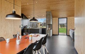 a dining room and kitchen with a table and chairs at Gorgeous Home In Jerup With Wifi in Jerup