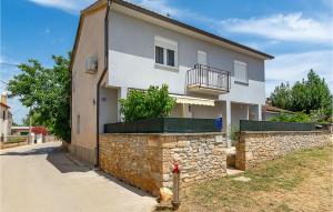 a white house with a stone wall and a fire hydrant at Beautiful Apartment In Sisan With Wifi in Šišan +20 photos