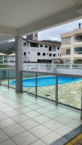 a view of the pool from the balcony of a building at AP IVONETE -Victoria Residense in Governador Celso Ramos
