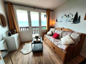 a living room with a couch and a table at Résidence Le Sextant - SEXTANT 304 MAE-0871 in La Plagne Tarentaise