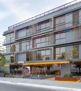 a large building with a university sign on it at Unity, Cabo Branco Flat 324 in João Pessoa