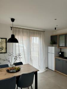 a kitchen with a dining room table with chairs and a window at Tornik view villa Zlatibor 2 in Ribnica