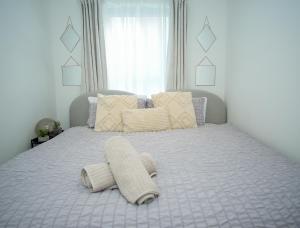 Una cama con dos toallas encima en un dormitorio. en Eastbourne Central Apartment Short and Long Stay welcome, en Eastbourne
