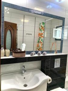 a bathroom with a sink and a mirror at Apartament Ultraconfort in Iaşi +23 photos