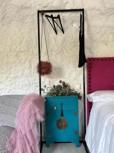 a bedroom with a blue cabinet next to a bed at De Alcalá al cielo Mon amour in Alcalá del Júcar