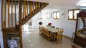 a dining room with a table and chairs at La poale de munte in Vistisoara