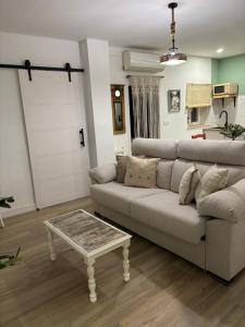 a living room with a couch and a table at El Olivo Verde in Jaén