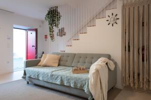a living room with a couch and a chess board on the floor at Casa dos Pescadores in Esposende +40 photos