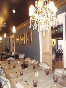 a dining room with a large table with a chandelier at Mercator in Vendôme