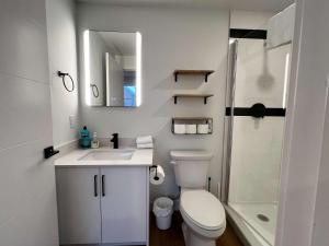 a bathroom with a toilet and a sink and a shower at Luxe Urban Retreat, Unit 602 in Halifax