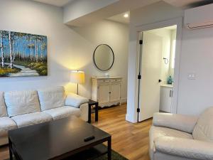 a living room with a white couch and a table at Luxe Urban Retreat, Unit 602 in Halifax