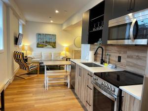 a kitchen with a sink and a counter top at Luxe Urban Retreat, Unit 602 in Halifax +16 photos