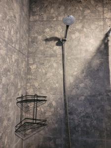 a shower with a shower head in a bathroom at Estudio Relax Las Sierras in El Volcán +21 photos