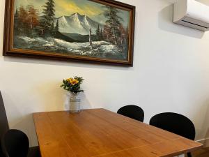 a dining room table with a vase of flowers on it at Urban Sophistication, Ocean View, Unit 513 in Halifax +16 photos