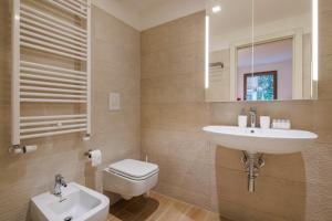 a bathroom with a sink and a toilet at Corte Trastevere Living in Rome +35 photos