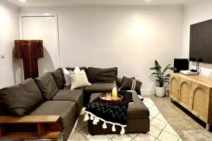 a living room with a couch and a table at Avalon Beach Guesthouse in Whale Beach