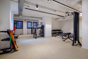 a gym with several treadmills and machines in a room at Corte Trastevere Living in Rome