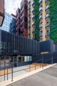a building with a black fence in front of a building at Corte Trastevere Living in Rome