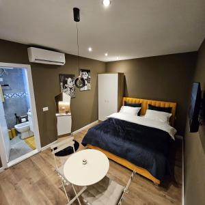 a bedroom with a bed and a white table at Selen GuestHouse in Tirana