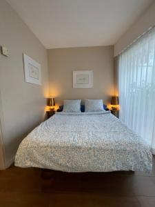 a bedroom with a large bed with two lamps at Royal lux promenade des anglais in Nice +4 photos